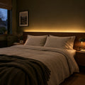 Warm white 3000K LED strip lighting installed behind a bedroom headboard
