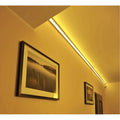 Warm white corner profile lighting a corridor wall and ceiling