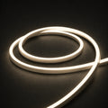 3000K horizontal-bend neon flex coil on dark charcoal with soft surface illumination; colour-adjusted product photograph