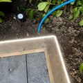 4000K neon flex light along a timber garden edge; colour-adjusted installation illustration