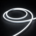6000K horizontal-bend neon flex coil on dark charcoal with soft surface illumination; colour-adjusted product photograph