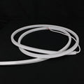 Unlit white horizontal-bend neon flex coil with silicone end cap and cable