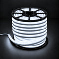 Cool white 6000K 8×16mm 220–240V wireless IP65 LED neon flex lit reel with open-spoke black top, visible light inside, end cap and cable on dark charcoal