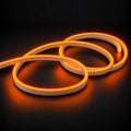 6x12mm LED neon flex with Orange illumination in overlapping loops on a dark charcoal surface.