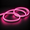 6x12mm LED neon flex with Pink illumination in overlapping loops on a dark charcoal surface.