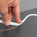 Installing 4x10mm FreeCut mini neon flex into a recessed groove in a furniture panel — illustration