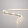 Warm white 3000K 4x10mm FreeCut mini neon flex in an S curve on a light surface — illustration