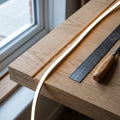 Mini neon flex seated in a routed groove in a cabinet rail