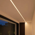 Plaster-in profile finished flush in the ceiling with a continuous warm white COB light line