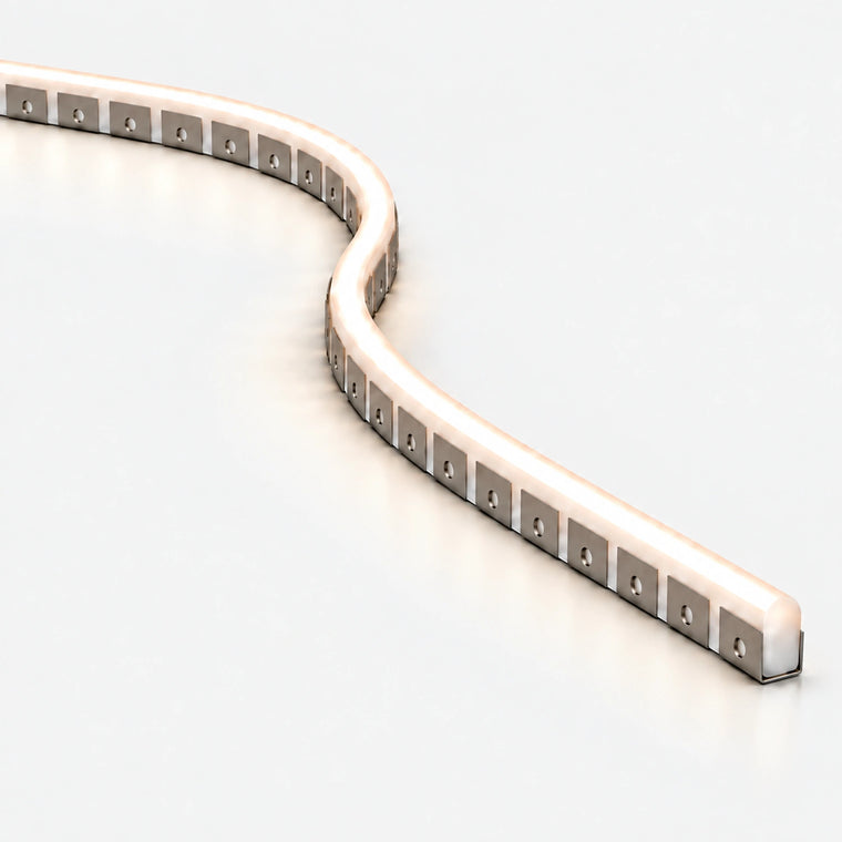 Close-up of a bendable aluminium mounting profile with glowing white LED neon flex installed in an S-shaped curve, on a pale grey background