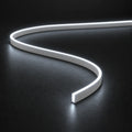 4x10mm FreeCut mini neon flex in cool white 6000K, curved on a dark surface — illustration