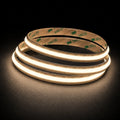 3000K Free Cut COB LED strip 24V 8mm IP20 illuminated coil on black background