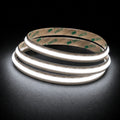 5000K Free Cut COB LED strip 24V 8mm IP20 illuminated coil on black background
