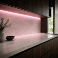 Illustrative indoor under-cabinet installation showing Pink SCOB LED strip lighting
