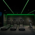 Green SCOB LED strip lighting installed in a modern cardio area — illustrative interior