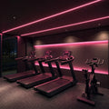 Pink SCOB LED strip lighting installed in a modern cardio area — illustrative interior