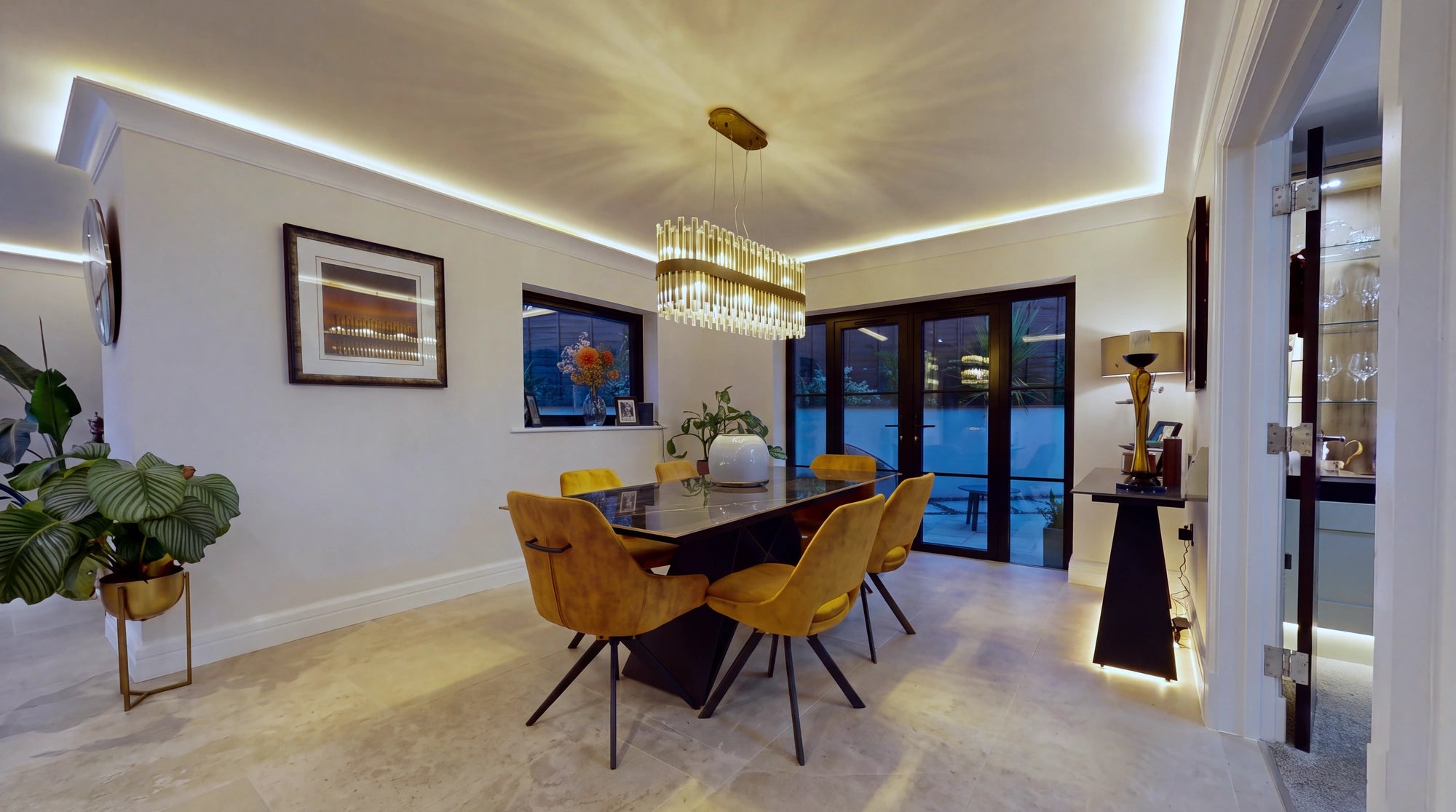 Dining area at night with a continuous warm white COB LED cove line running around the full ceiling perimeter