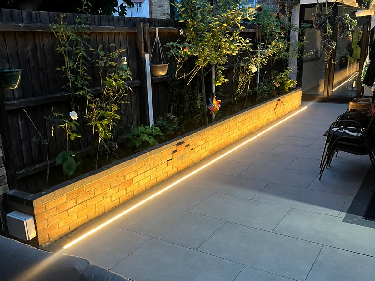Long recessed 48V neon flex run beside a raised garden border