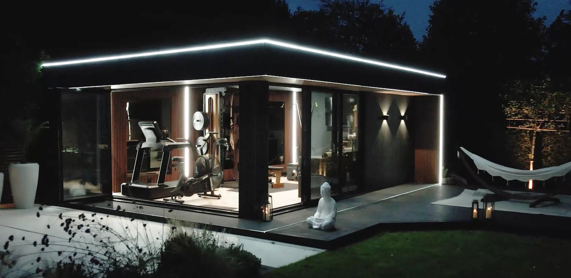 Garden room at night, IP67 neon flex along the roofline and warm interior lighting