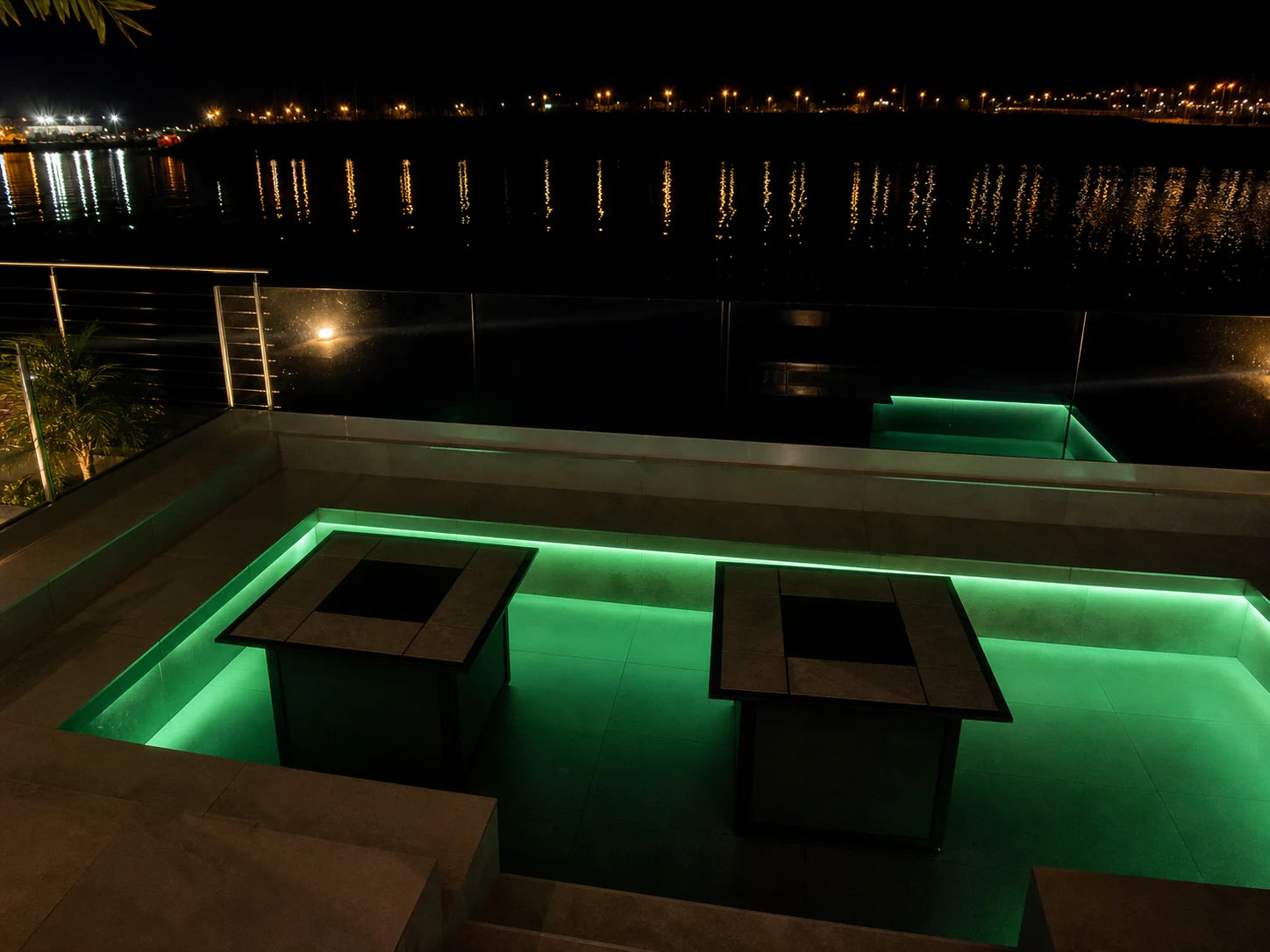 Outdoor terrace seating perimeter lit in green digital pixel RGB neon flex