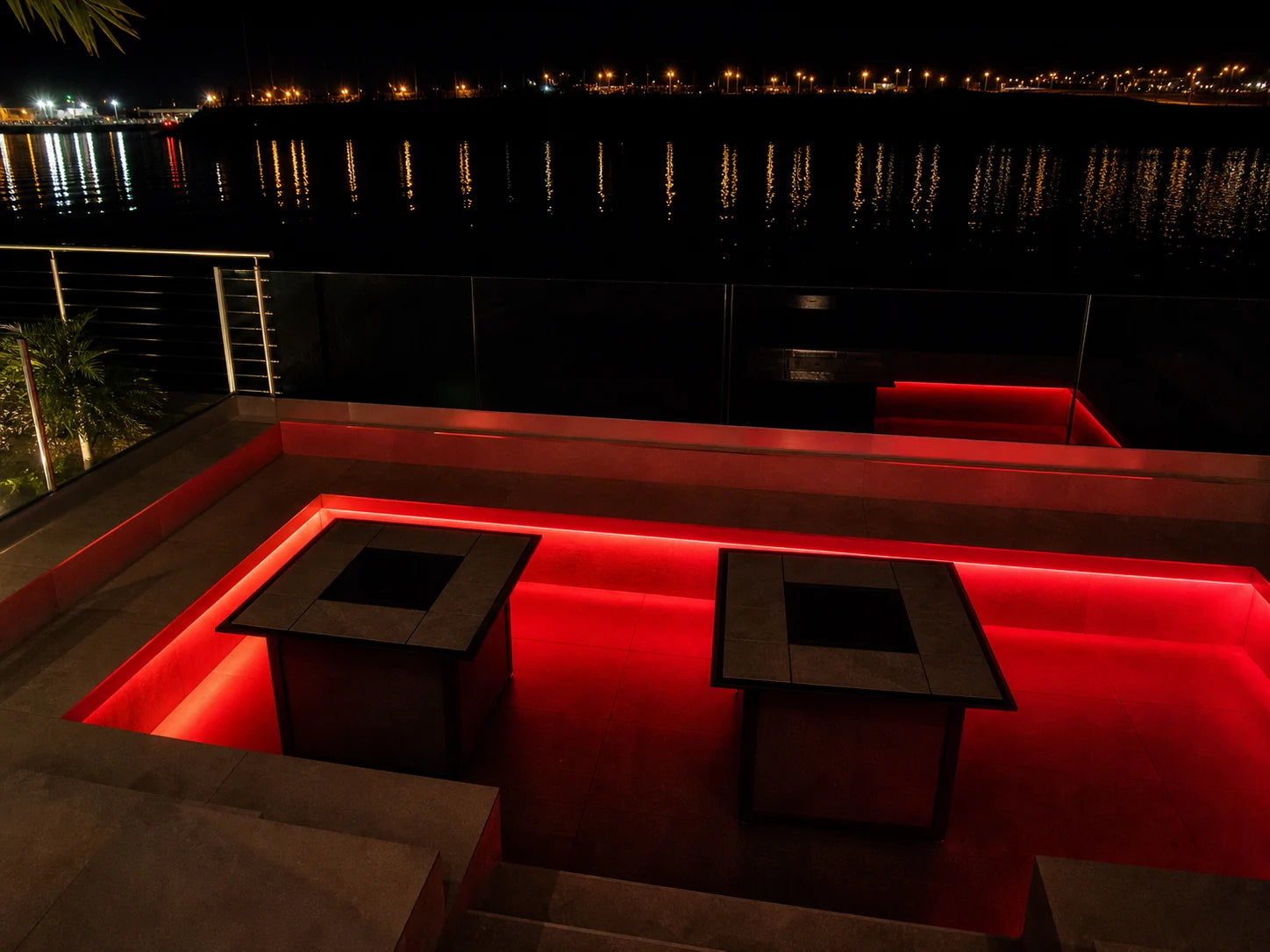 Outdoor terrace seating perimeter lit in red digital pixel RGB neon flex