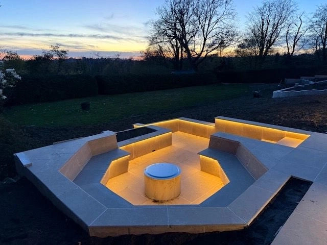 Overhead-style view of the hex seating well showing the full perimeter glow with the central fire-bowl