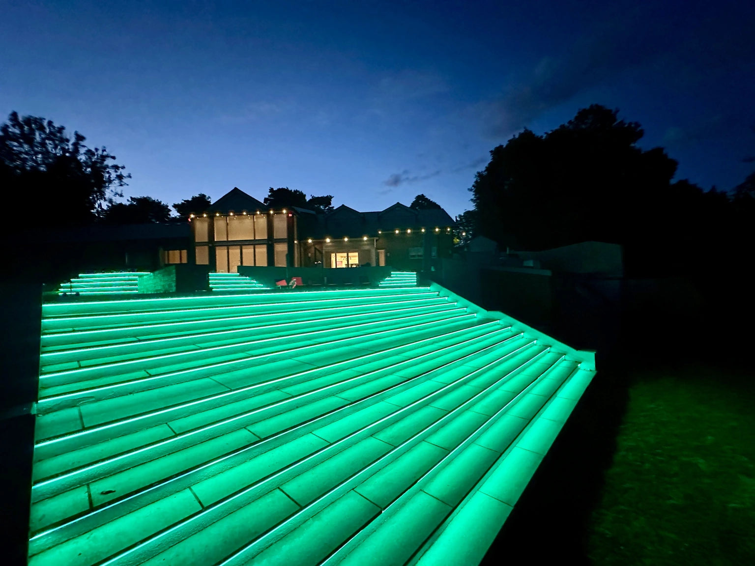 Step risers at twilight in teal showing the RGB COB output across the full run