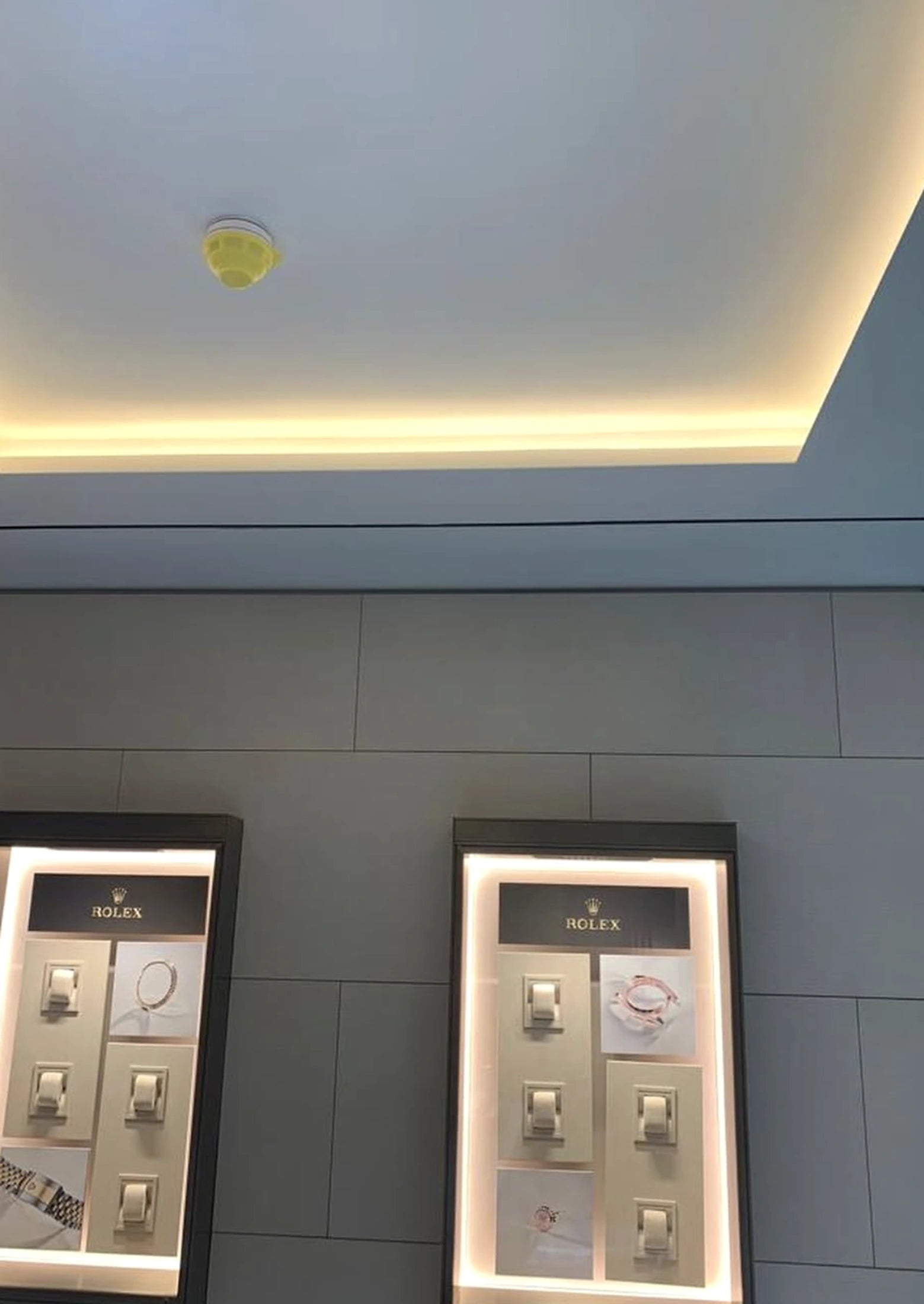 Rolex London showroom ceiling cove with warm white COB LED strip lighting around the tray